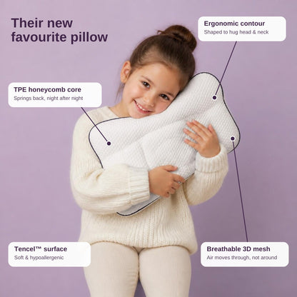 Girl hugging the Little Rheva pillow, with material callouts